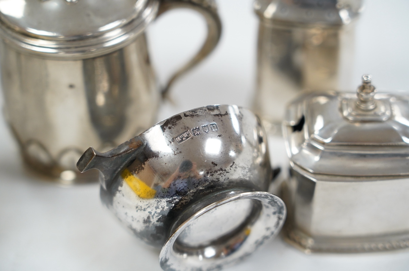 Five assorted silver condiments, including Chinese white metal modelled a rickshaw, together with a plated tea kettle stand with burner. Condition - poor to fair